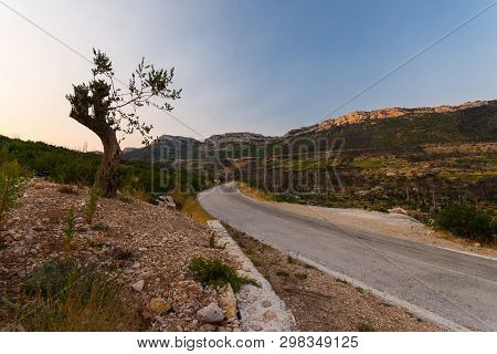 Road To Small Village Trstenik In Peljesac Peninsula, With Mountins And Blue Sky As Background
