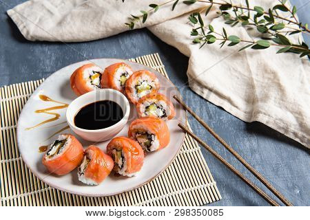 Philadelphia Roll Sushi With Salmon And Cucumber Served On The Plate With Soe Sauce. Copy Space