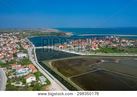 Aerial View Of City Of Nin. Summer Time In Dalmatia Region Of Croatia. Coastline And Turquoise Water