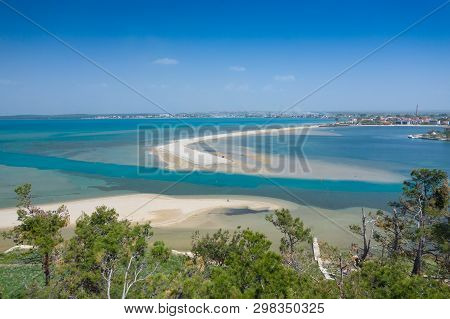 Aerial View Of City Of Nin. Summer Time In Dalmatia Region Of Croatia. Coastline And Turquoise Water