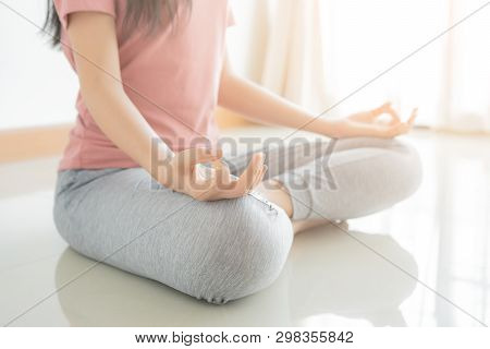 Close Up Hand And Half Body Of Healthy Woman Sit In Lotus Yoga Position.young Healthy Woman Sitting 