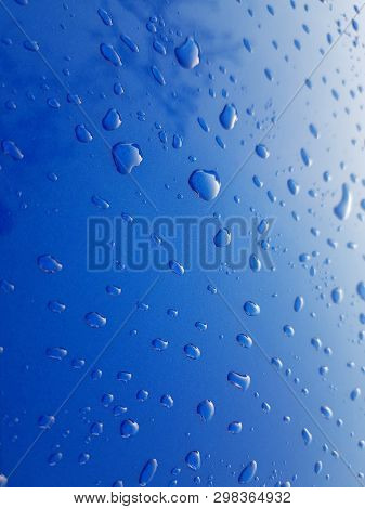 Drops Of Rainwater On Blue Metal Background After Nanoceramics Polishing Technology Closeup