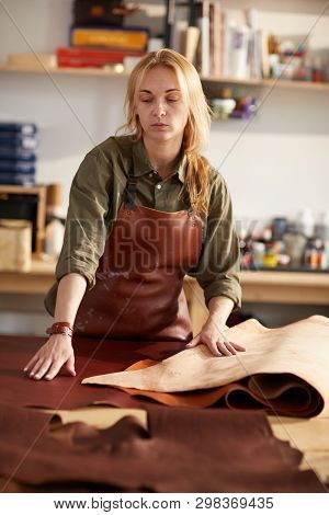 Waist Up Portrait Of Female Tanner Working With Leather In Workshop, Copy Space