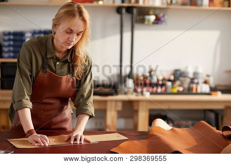 Waist Up Portrait Of Female Artisan Working With Leather In Workshop, Copy Space