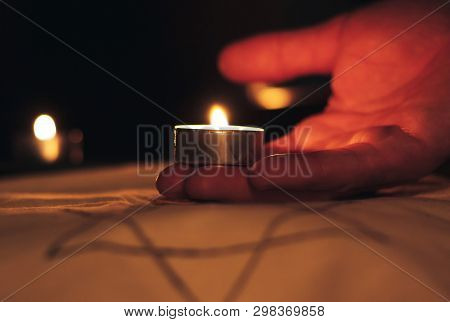 Candles Burning Over The Star Of David In Memory Of The Dead.