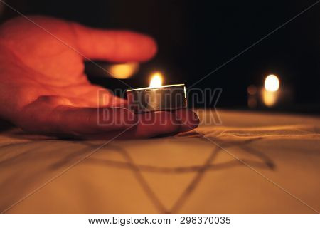 Candles Burning Over The Star Of David In Memory Of The Dead.
