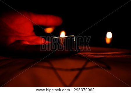 Candles Burning Over The Star Of David In Memory Of The Dead.
