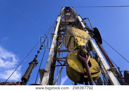 Oil And Gas Drilling Rig Onshore Dessert With Dramatic Cloudscape. Oil Drilling Rig Operation On The