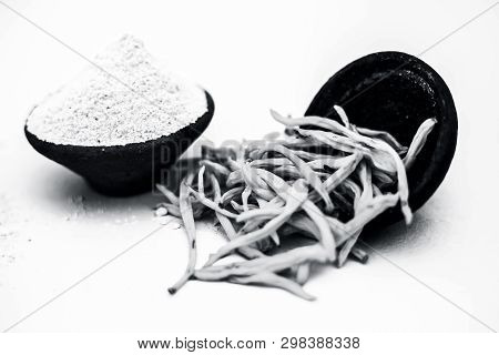 Popular Indian & Asian Ayurvedic Herb Isolated On White In A Clay Bowl I.e. Musli Or Safed Musli Or