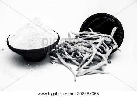 Popular Indian & Asian Ayurvedic Herb Isolated On White In A Clay Bowl I.e. Musli Or Safed Musli Or