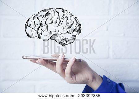 Businesswoman Holding Smart Phone With Brain In Screen