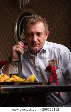 Fabulous At Any Age. Portrait Of Fashionable 50-year-old Man In Stylish Siut Posing At Restaurant. T