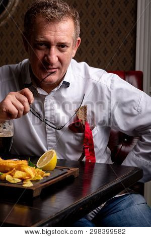 Fabulous At Any Age. Portrait Of Fashionable 50-year-old Man In Stylish Siut Posing At Restaurant. T
