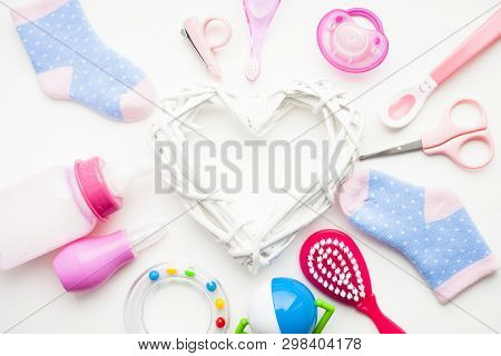 Newborn Baby Story. Strow Heart And Childrens Toys, Scissors, Baby Bottle, Nipple, Hairbrush On Whit