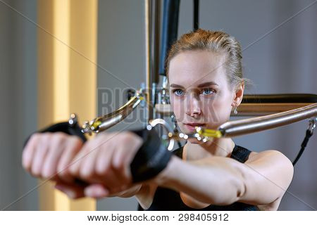 Gym Woman Pilates Stretching Sport In Reformer Bed Instructor Girl. Selective Focus On Hands