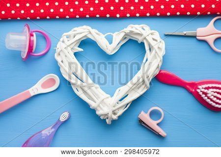 Newborn Baby Story. Strow Heart And Childrens Toys, Scissors, Baby Bottle, Nipple, Hairbrush On Blue