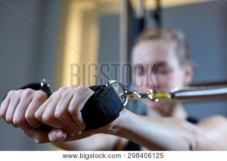 Gym Woman Pilates Stretching Sport In Reformer Bed Instructor Girl. Selective Focus On Hands