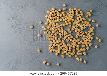 Top View Of Clean Fresh Garbanzo Or Chickpeas On Grey Background. Flat Lay. Raw Food For Vegans. Clo