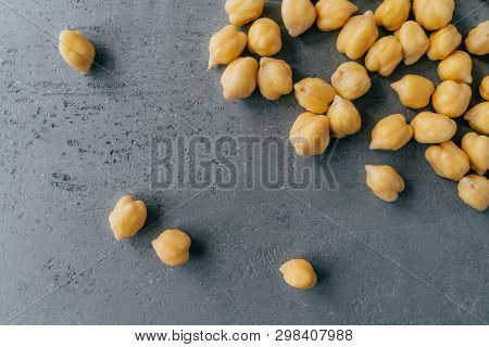 Natural Food Ingredients And Healthy Eating Concept. Dry Raw Chickpeas On Dark Background. Protein F