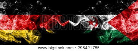 Germany Vs Sahrawi Smoky Mystic Flags Placed Side By Side. Thick Colored Silky Smoke Flags Of Deutsc