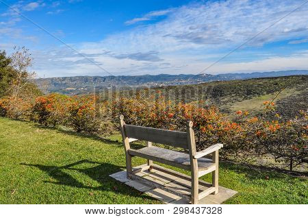 Wooden Bench Overlooking Valley In The Fall