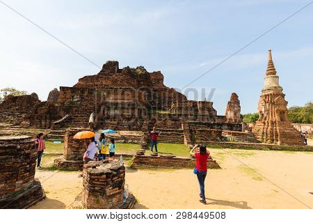 People Visiting The Temple Of Ayutthaya Historical Park On Thailand..