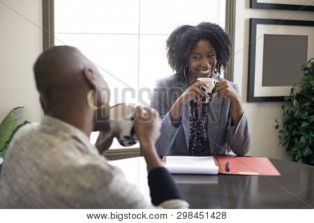 Black African American Female Businesswomen Talking In An Office.  The Two Women Looks Like A Start 