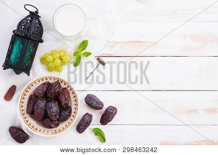 Ramadan Food And Drinks Concept. Ramadan Lantern With Milk, Dates Fruit, Grape And Mint Leaves On A 
