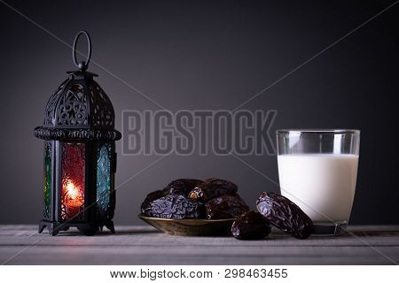 Ramadan Food And Drinks Concept. Ramadan Lantern With Milk, Dates Fruit On Wooden Table Background.
