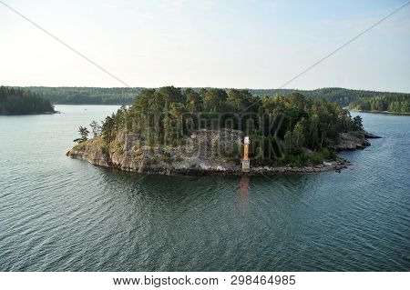 Rocky Island In The Baltic Sea With Lighthouse And Forest