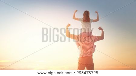 Happy loving family. Father and his daughter child playing and hugging outdoors. Cute little girl and daddy. 