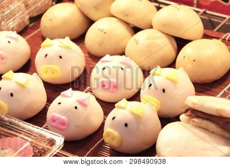 Street food - traditional Chinese animal-shaped mantou buns - pigs and chicken, street market in Chinatown, Kobe, Japan