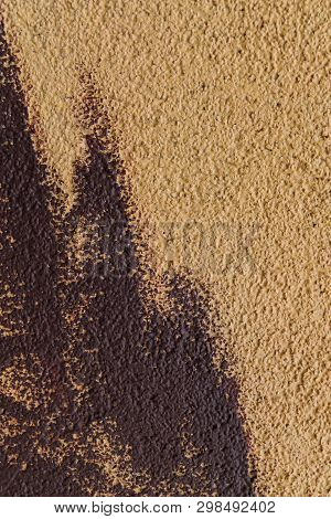 Blurred Abstract Background. Texture Of Beige Painted Concrete Rough Surface With Coarse Brown Brush