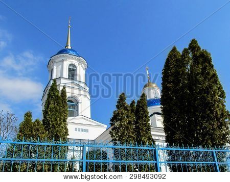 Sumy, Ukraine - April 1, 2019: Bell Tower With White Walls, Blue Dome And Golden Spire Of Temple Of 