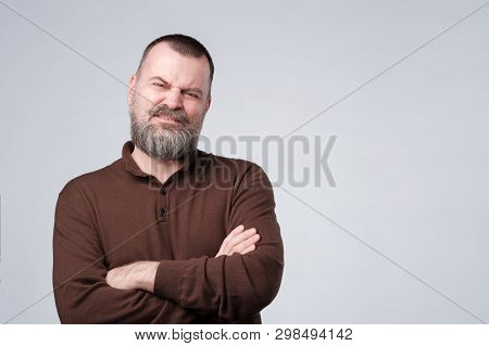 Angry, Pissed Off Mature Man With Arms Crossed Folded.