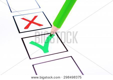 White Bulletin With Checkboxes And Green Pencil With Red Cross And Tick Drawn As Positive And Negati
