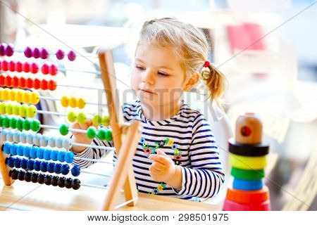Adorable Cute Beautiful Little Toddler Girl Playing With Educational Wooden Rainbow Toy Pyramid And 