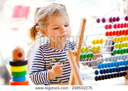 Adorable Cute Beautiful Little Toddler Girl Playing With Educational Wooden Rainbow Toy Pyramid And 