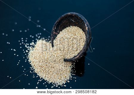 Close Up Of Clay Bowl On Wooden Surface Full Of Poppy Seeds Or Khus Or Opium Poppy Or Breadseed Popp