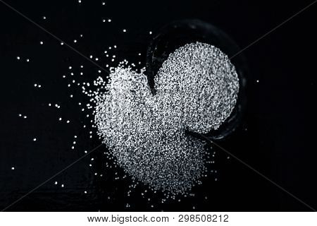 Close Up Of Clay Bowl On Wooden Surface Full Of Poppy Seeds Or Khus Or Opium Poppy Or Breadseed Popp