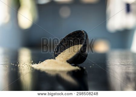 Close Up Of Clay Bowl On Wooden Surface Full Of Poppy Seeds Or Khus Or Opium Poppy Or Breadseed Popp