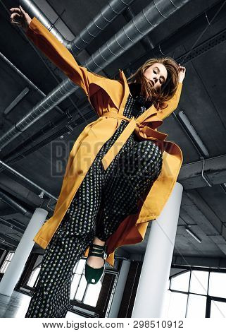 Young Woman In Yellow Coat