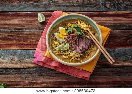 Bowl Of Boiled Noodles With Sweet Potato Gravy, Malaisan Cuisine Mee Rebus, Copy Space.