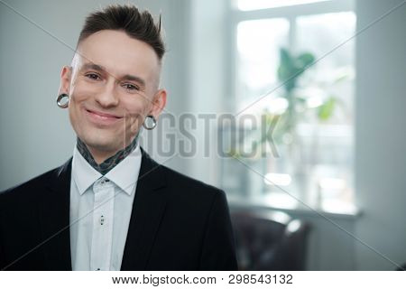 Portrait of alternative model with earplugs and tattoo