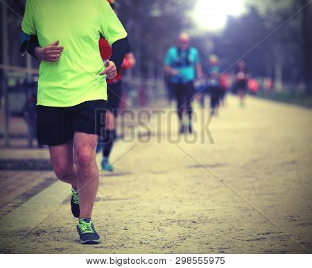 Runner Runs With Many People In The Country Road Race With Old Toned Effect