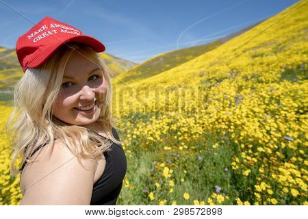 Taft, California - March 25, 2019: Blonde Republican Woman Wears A Donald Trump Make America Great A