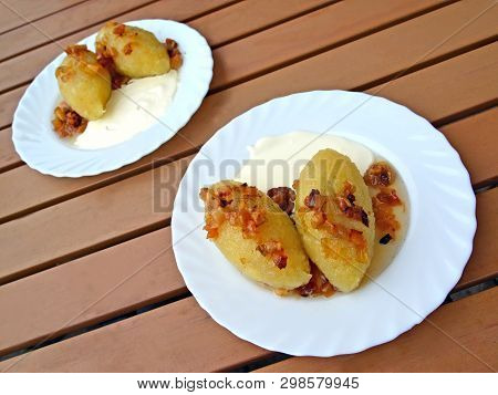 Two Plates With Potato Zrazas Lie On A Table. Traditional Lithuanian Dish