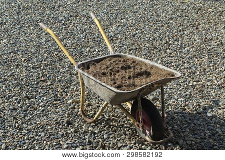 Garden Cart Stands On The Rocks, Loaded With Sand