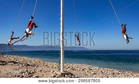 Papantla Flyers With A Wonderful Blue Sky, An Ancient Mexican Tradition (mexican Pre-columbian Aeria