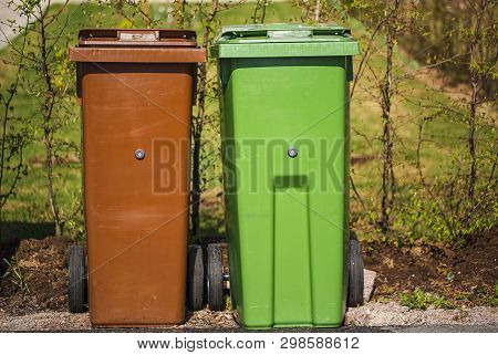 Close up view of typical garbage containers for organig and non-organic garbage. Environment concept.